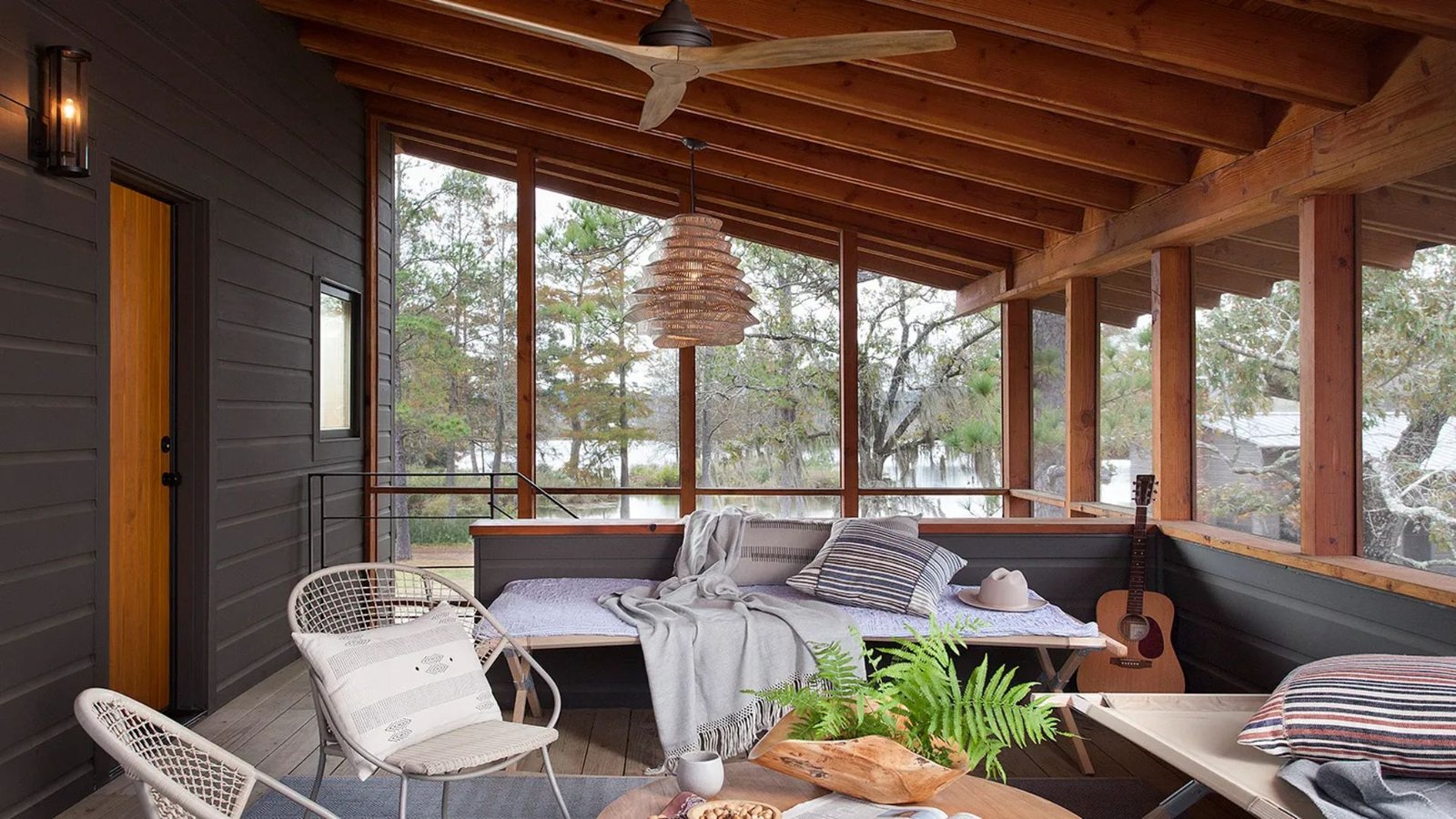 A cozy porch featuring a couch, a table, and chairs, inviting relaxation and outdoor gatherings.
