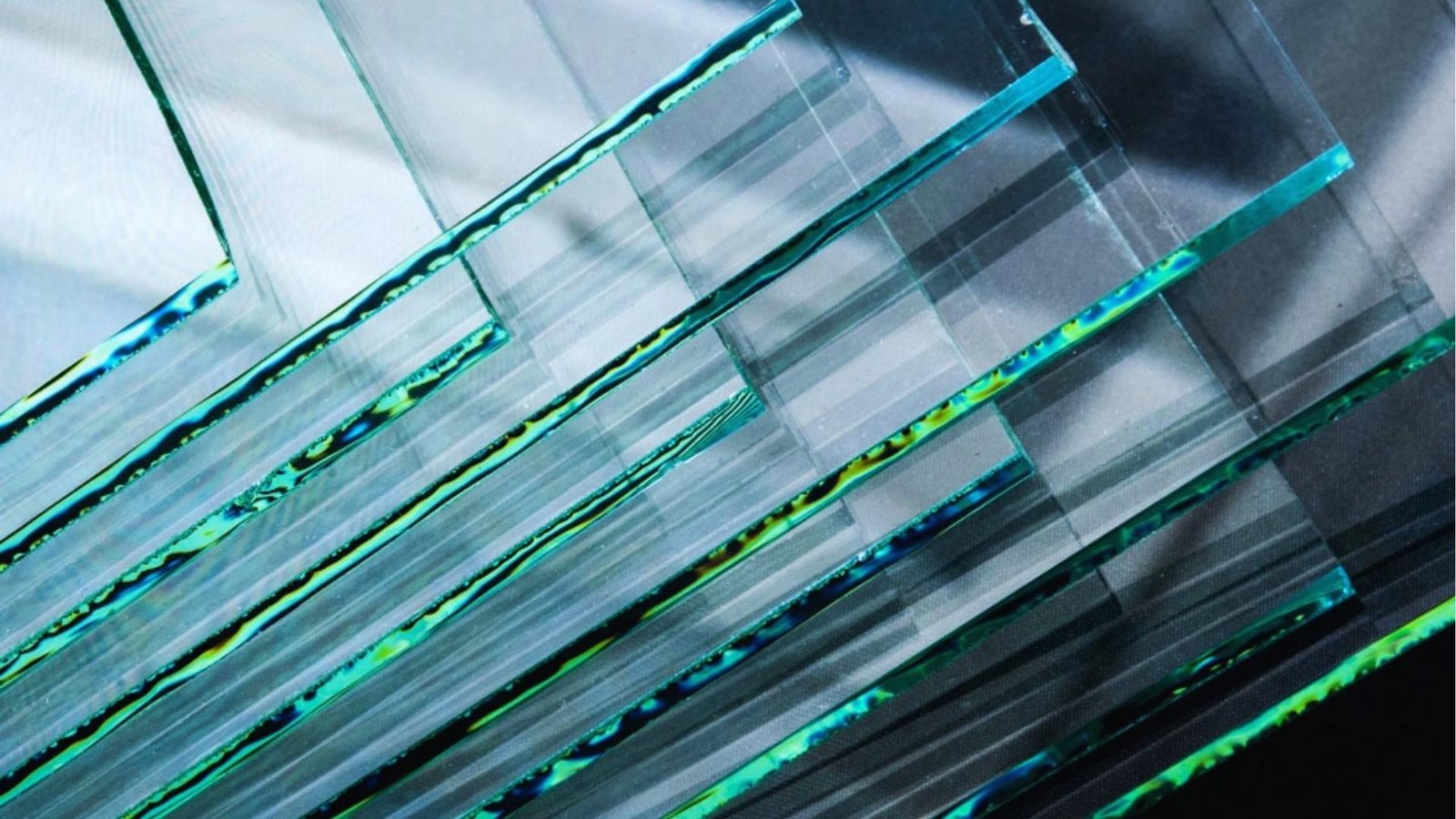 Close-up of glass panels featuring vibrant green and blue stripes, showcasing a modern design element.