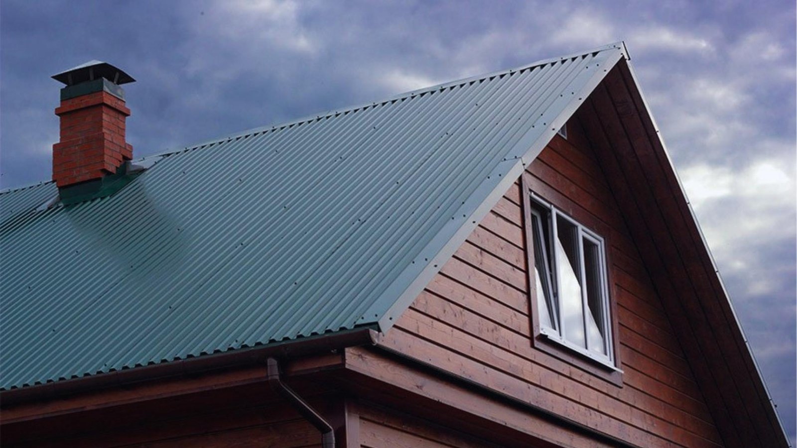  charming house with a green roof and chimney, surrounded by a serene landscape.
