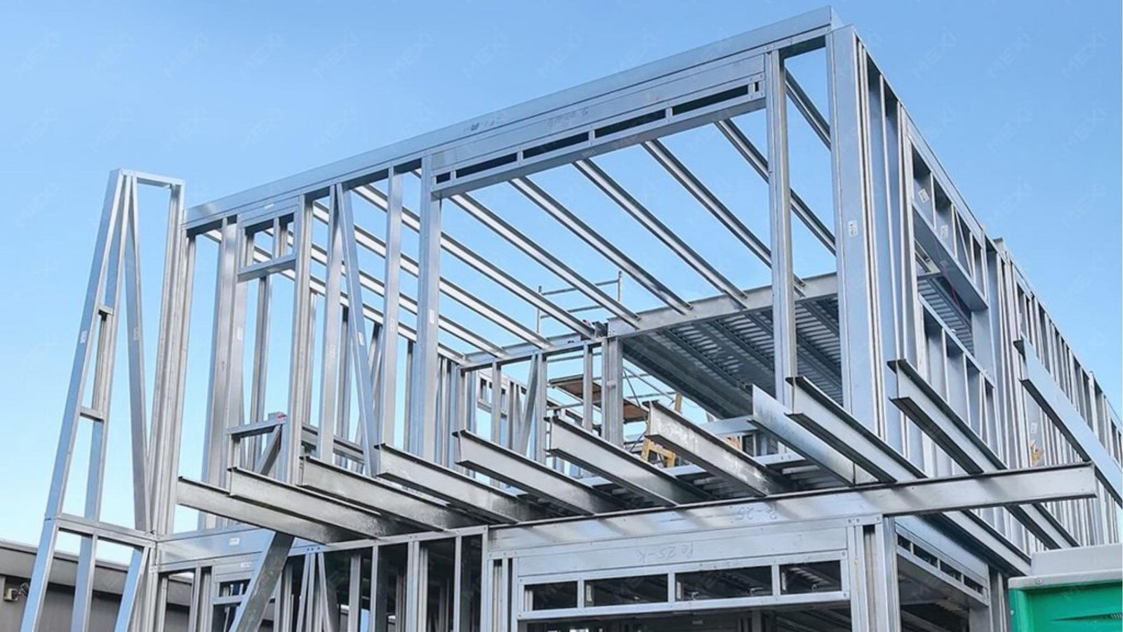  modern building featuring exposed steel framing and large windows, showcasing an industrial architectural style.