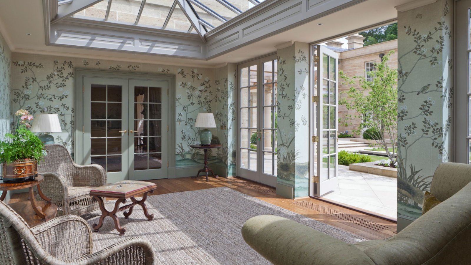 A sunroom featuring a skylight and a wicker chair, creating a bright and inviting atmosphere.