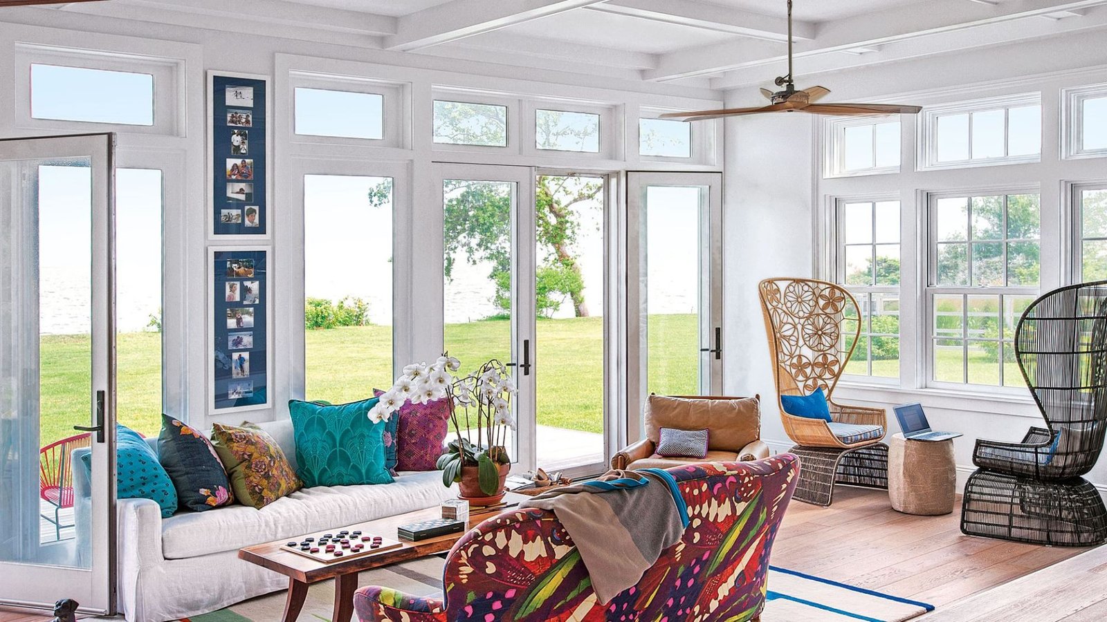 A sunroom featuring a large window that lets in natural light, with a comfortable couch positioned nearby.