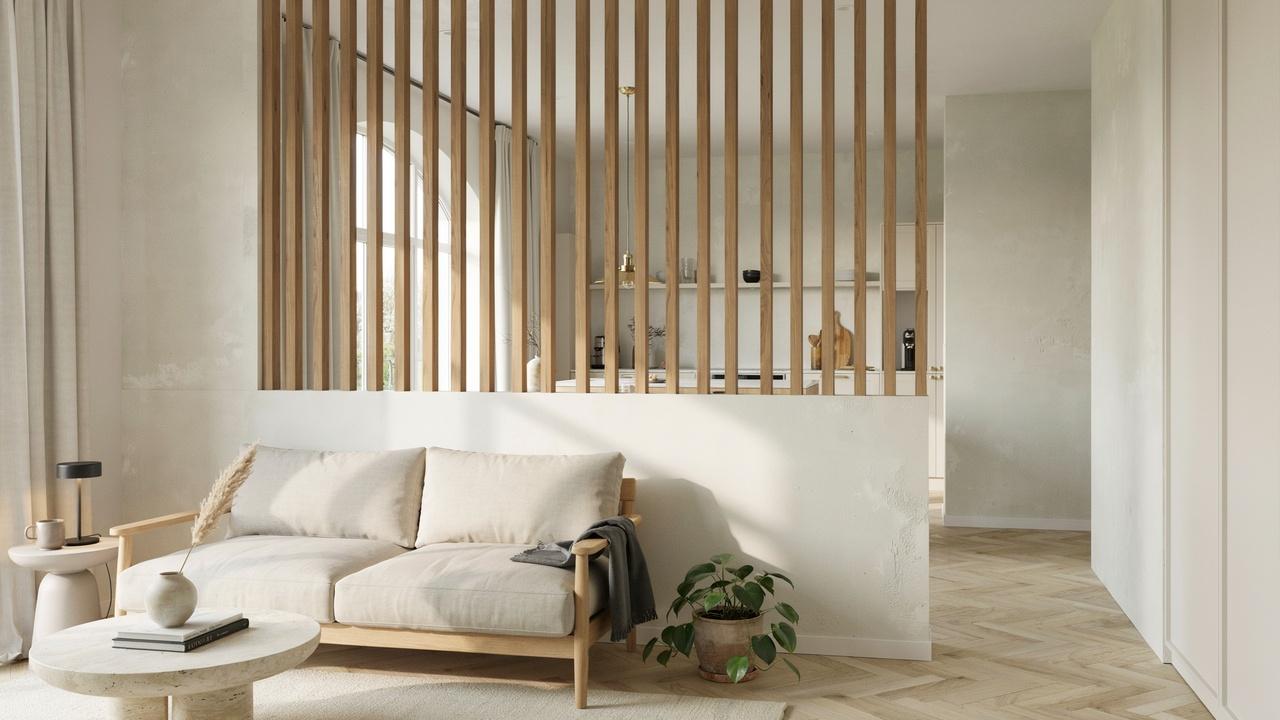 Half wall divider with vertical wooden slats adding texture and privacy.